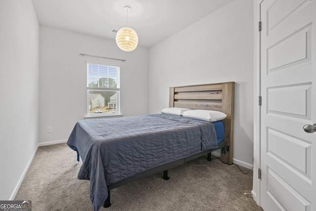 carpeted bedroom featuring baseboards