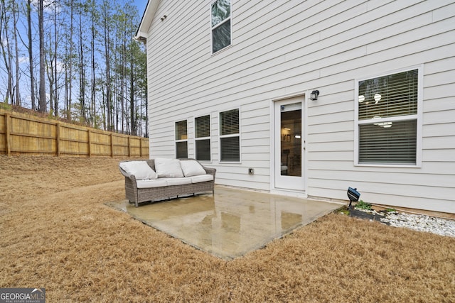 rear view of property featuring a patio and fence