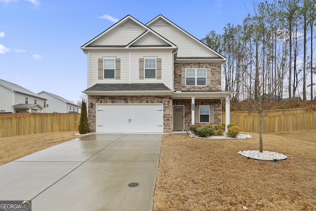 craftsman inspired home with a garage, stone siding, driveway, and fence