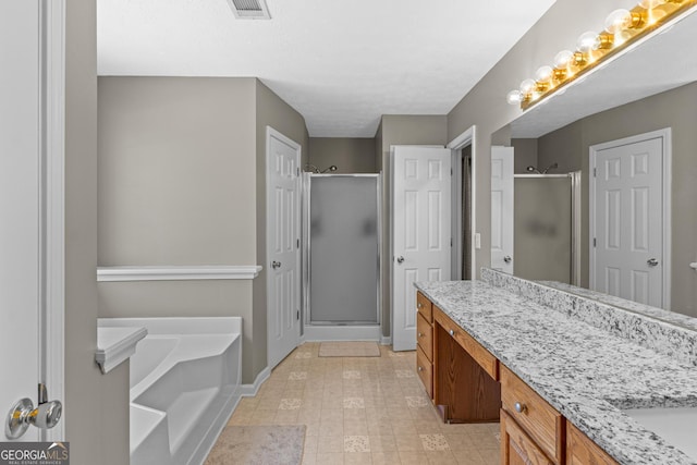 full bath with visible vents, baseboards, a garden tub, vanity, and a shower stall