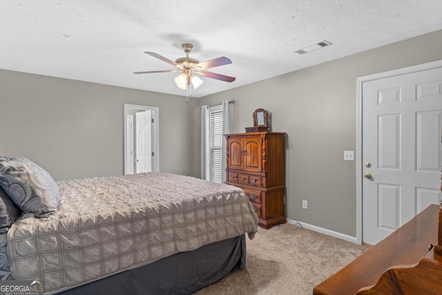 bedroom featuring visible vents, a ceiling fan, carpet flooring, a textured ceiling, and baseboards