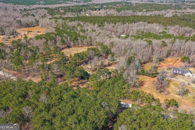 birds eye view of property with a wooded view