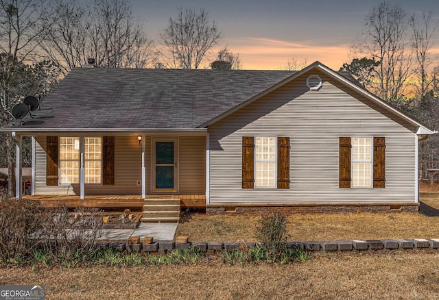 view of front facade with crawl space, a shingled roof, and a porch