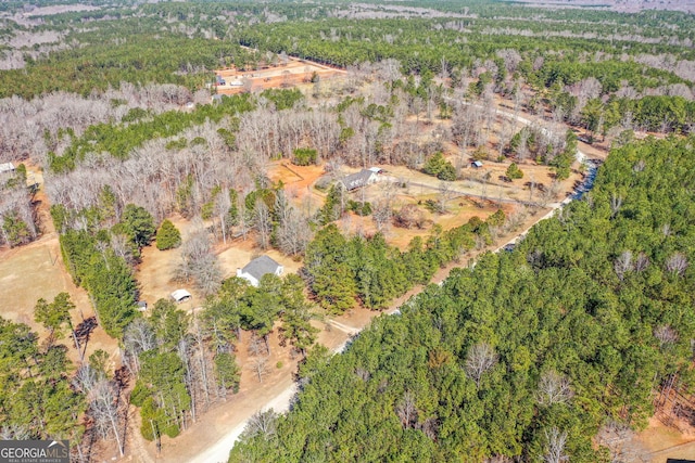 birds eye view of property with a wooded view