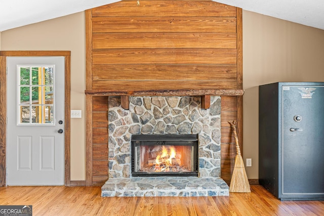 room details featuring a fireplace, baseboards, and wood finished floors