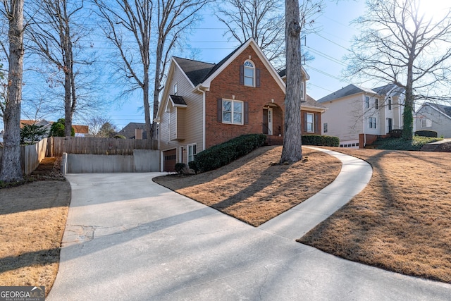 view of front of property featuring brick siding and fence