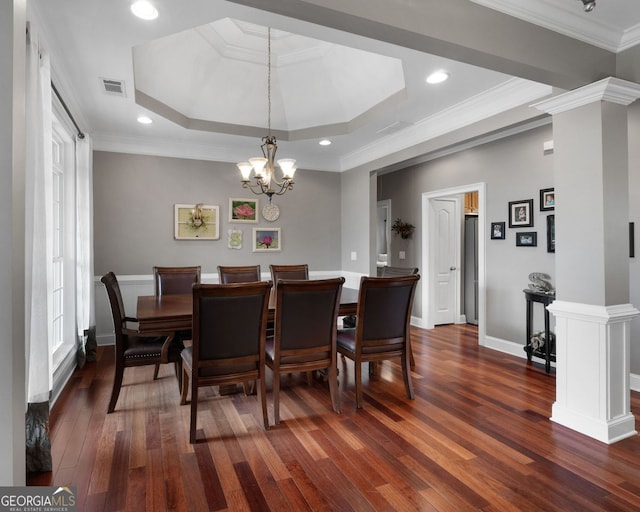 dining area with dark wood-style flooring, crown molding, a raised ceiling, visible vents, and baseboards