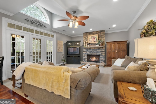 living room featuring ceiling fan, ornamental molding, french doors, a fireplace, and recessed lighting