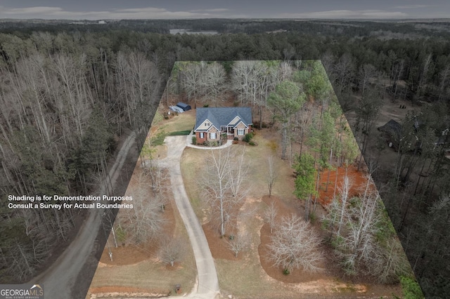 drone / aerial view with a wooded view