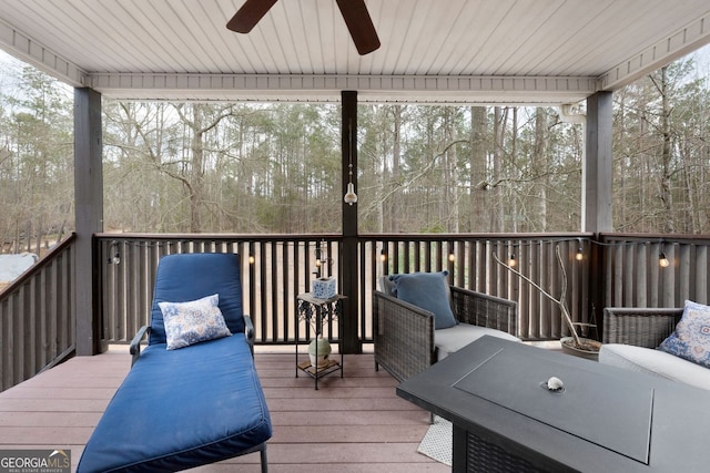 wooden terrace featuring a ceiling fan