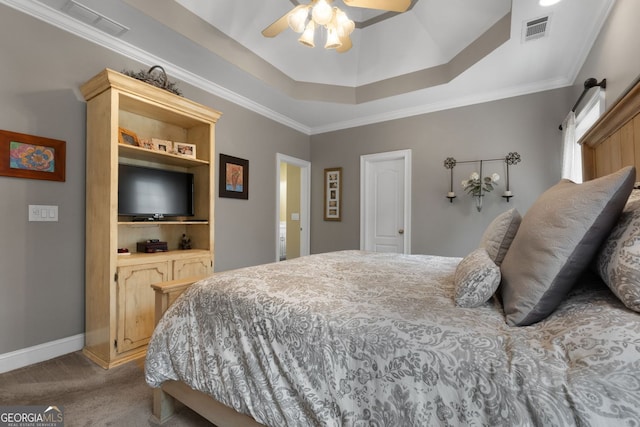 carpeted bedroom featuring a raised ceiling, visible vents, ornamental molding, a ceiling fan, and baseboards