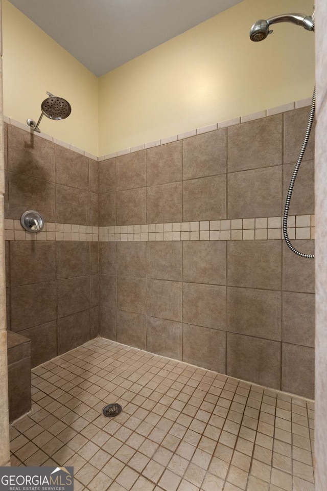 full bath featuring tiled shower