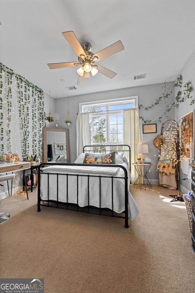 bedroom with carpet, visible vents, and a ceiling fan