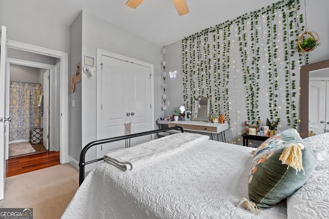 carpeted bedroom featuring ceiling fan and a closet