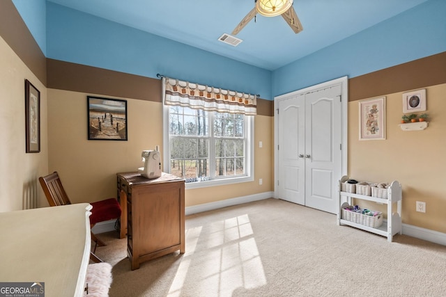 carpeted home office with baseboards, visible vents, and ceiling fan