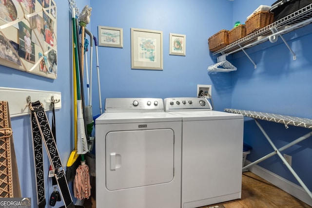 clothes washing area with laundry area, washing machine and dryer, and tile patterned floors