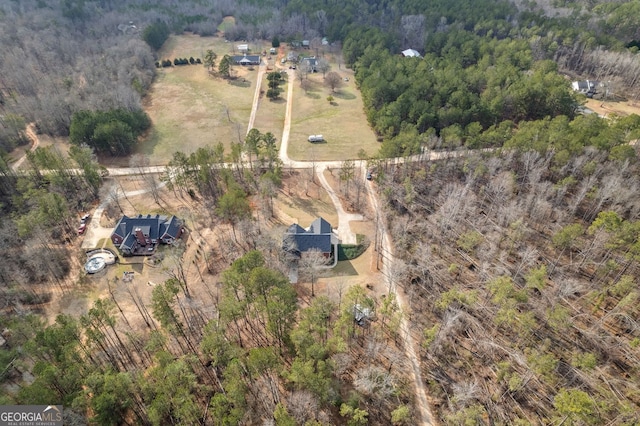 birds eye view of property with a rural view and a view of trees