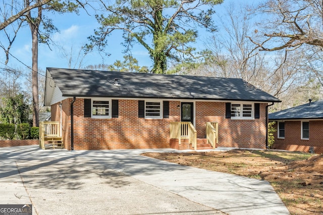 view of front of house featuring brick siding and driveway