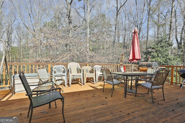 wooden terrace featuring outdoor dining space