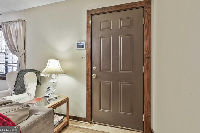 interior space with light wood-type flooring and baseboards