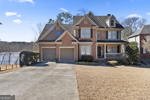 view of front of home featuring concrete driveway, a porch, and brick siding