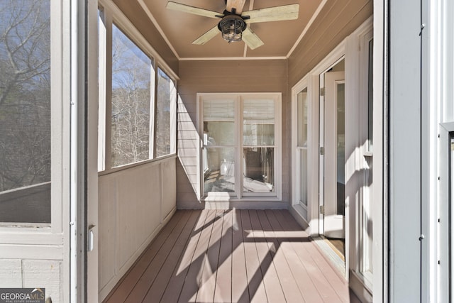 unfurnished sunroom featuring a ceiling fan