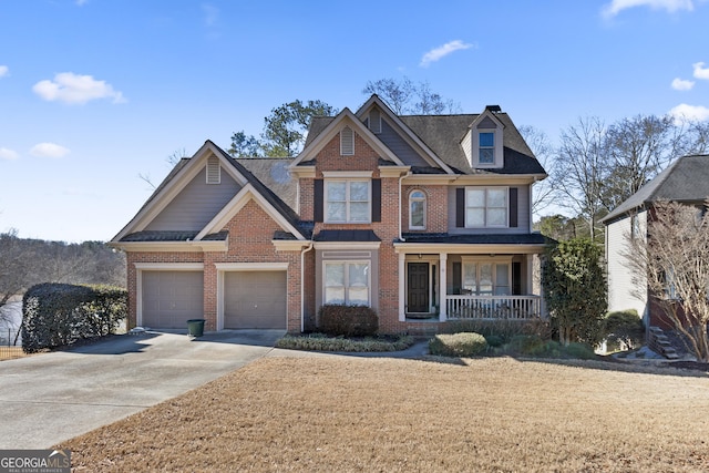 craftsman-style home with a porch, brick siding, driveway, and a garage