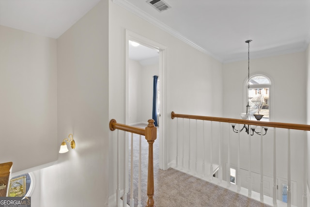 stairs with visible vents, crown molding, and carpet flooring