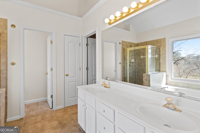 bathroom featuring a stall shower, tile patterned flooring, a sink, and crown molding