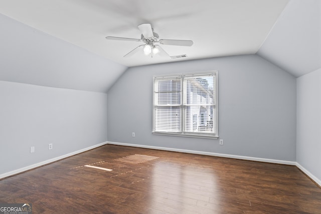 additional living space featuring lofted ceiling, visible vents, baseboards, and wood finished floors