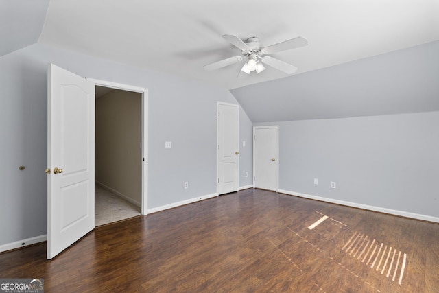 additional living space featuring baseboards, vaulted ceiling, and wood finished floors