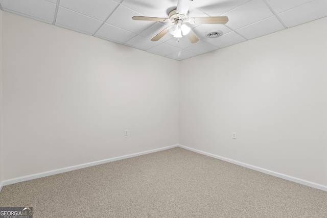 carpeted empty room featuring visible vents, a paneled ceiling, a ceiling fan, and baseboards