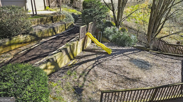 view of yard with fence and a playground