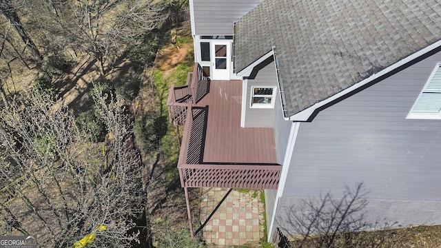 view of side of property featuring roof with shingles