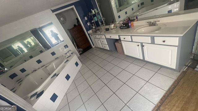 kitchen with light tile patterned floors, light countertops, a sink, and white cabinetry