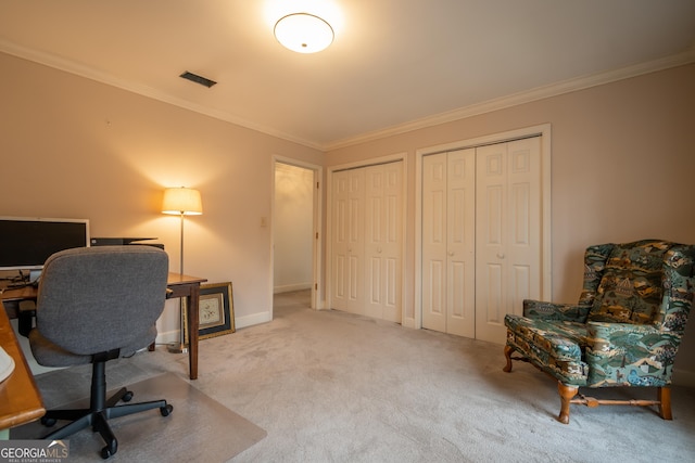 office area featuring carpet floors, visible vents, and ornamental molding