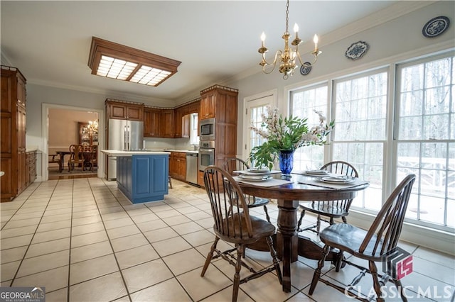 kitchen with stainless steel appliances, light countertops, light tile patterned flooring, and ornamental molding