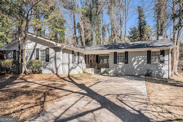 single story home featuring brick siding