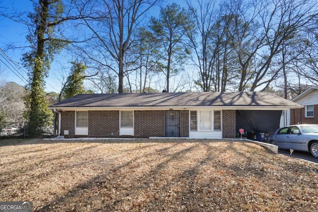 ranch-style house with brick siding, a front lawn, and an attached garage