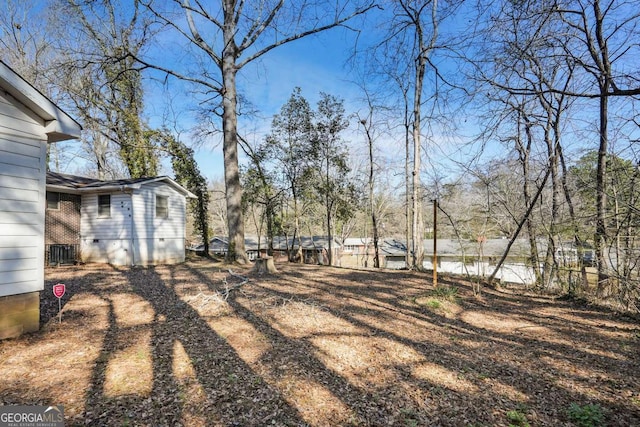 view of yard featuring cooling unit and fence