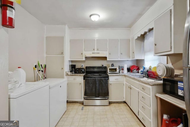 kitchen with under cabinet range hood, white cabinetry, light countertops, black appliances, and washing machine and clothes dryer