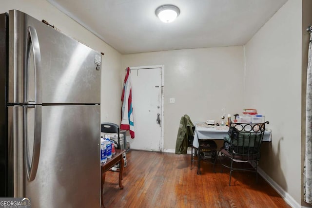 kitchen with freestanding refrigerator, baseboards, and wood finished floors