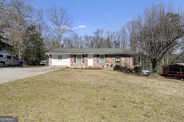 ranch-style house with concrete driveway, brick siding, and a front yard