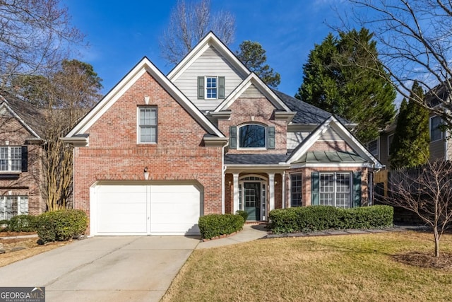 traditional-style house with a garage, brick siding, driveway, and a front lawn