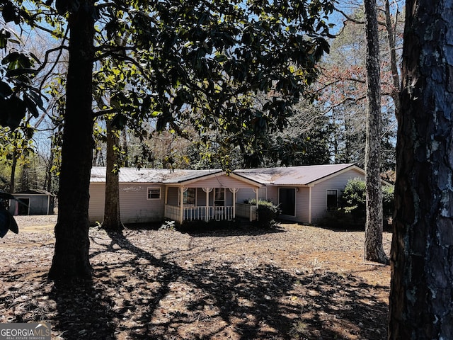 view of front of home featuring covered porch and metal roof