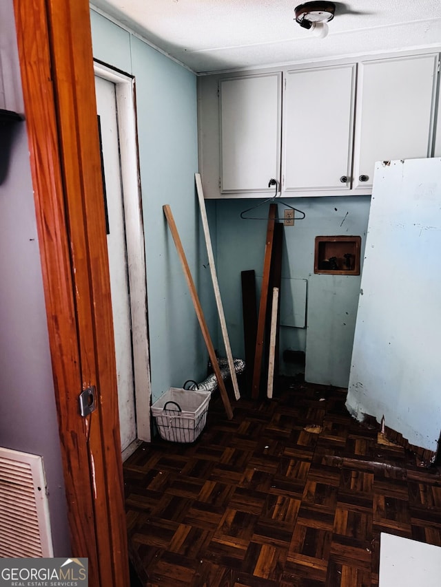 clothes washing area featuring cabinet space, hookup for a washing machine, and visible vents