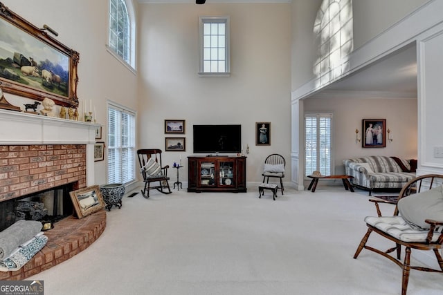 living room with plenty of natural light, a brick fireplace, and carpet