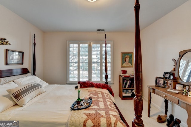 carpeted bedroom featuring visible vents