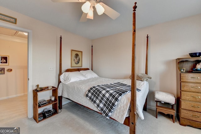 bedroom with attic access, carpet flooring, and a ceiling fan