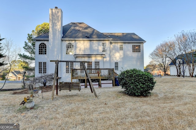 back of house with a chimney and a wooden deck